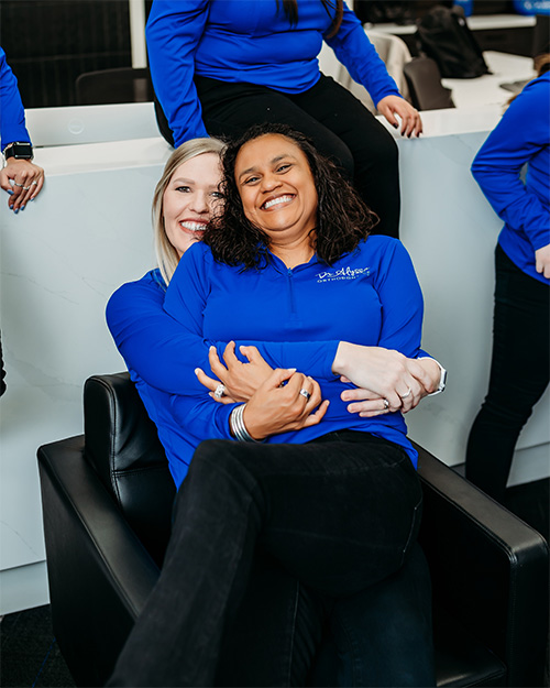 orthodontic team members hugging and having fun