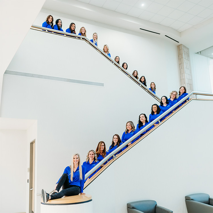 Orthodontic team posed on staircase