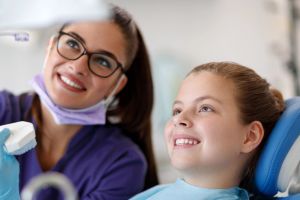 Young girl smiling while at orthodontic appointment