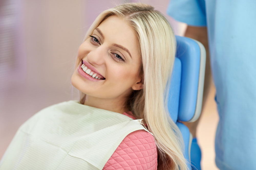 Smiling young woman at orthodontic appointment