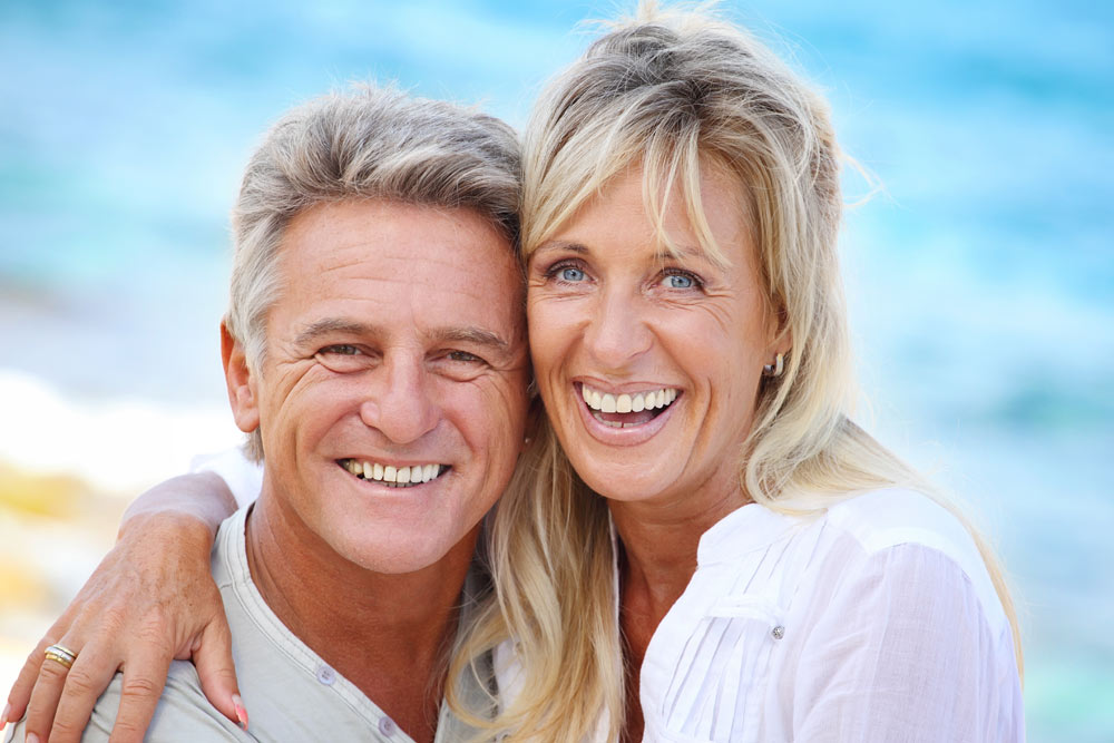 Smiling older couple in outdoor setting | Adult Orthodontics in Sherman, TX